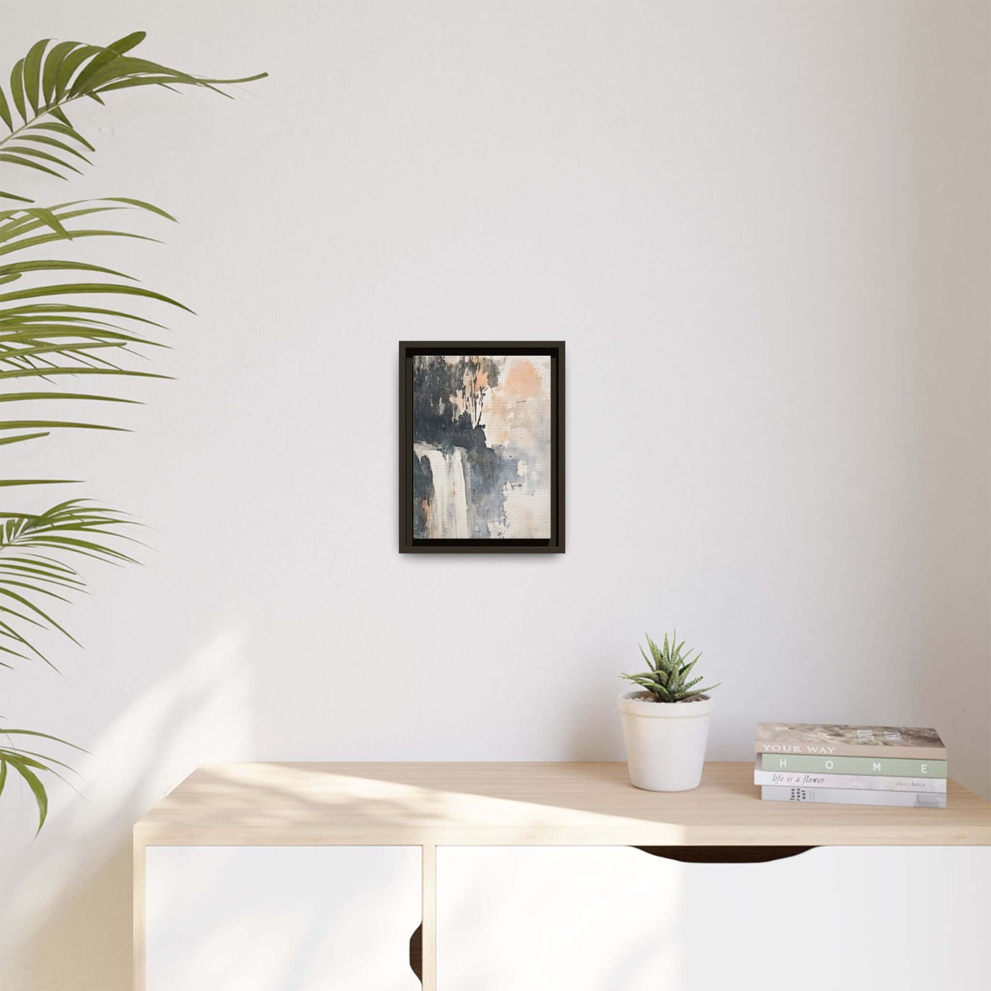 Framed waterfall art print on matte canvas, displayed in modern home decor setting with plant and books, wall size 9x12 inches.