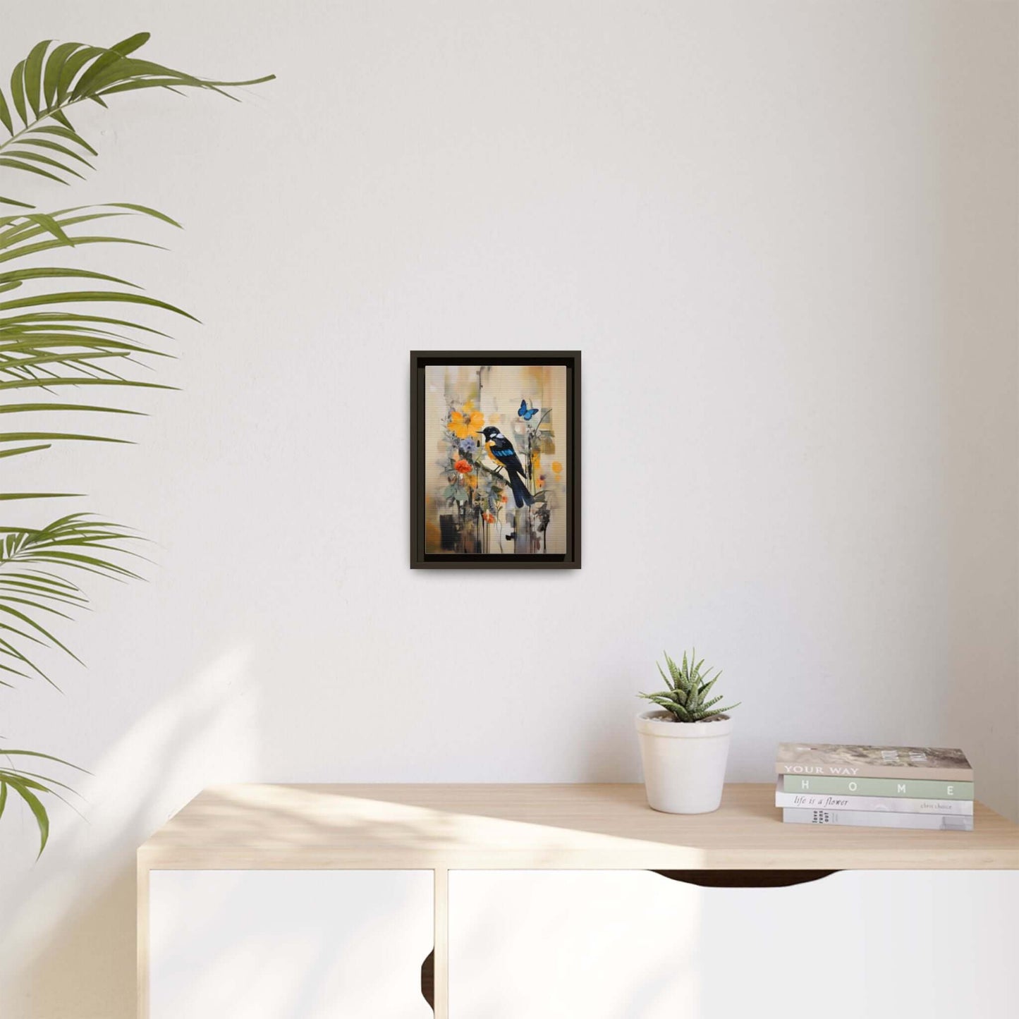 Framed vibrant bird and butterfly canvas art on a minimalist wall, perfect for colorful home decor.