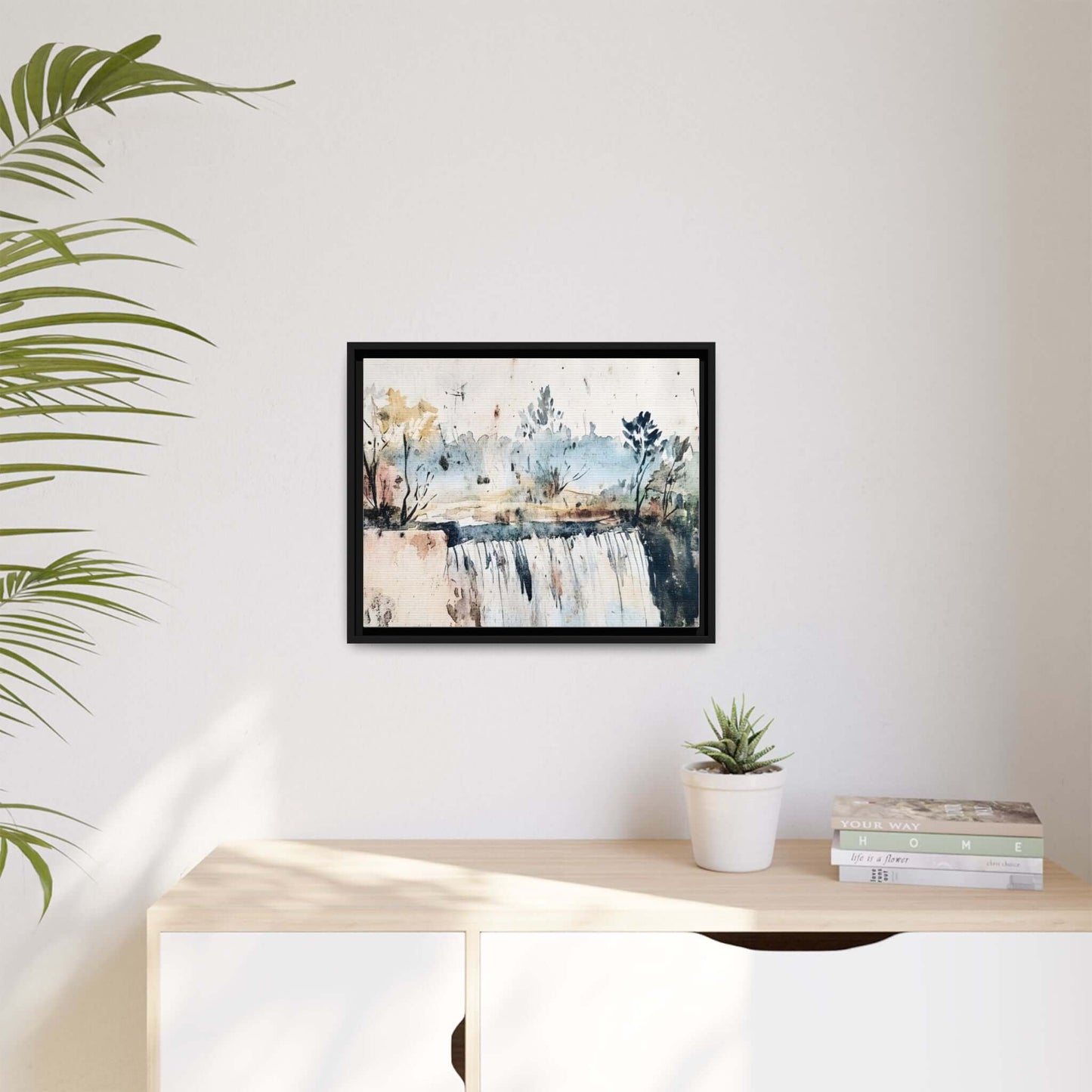 Framed watercolor wall art featuring serene landscape, displayed on a minimalist shelf with a potted plant and books