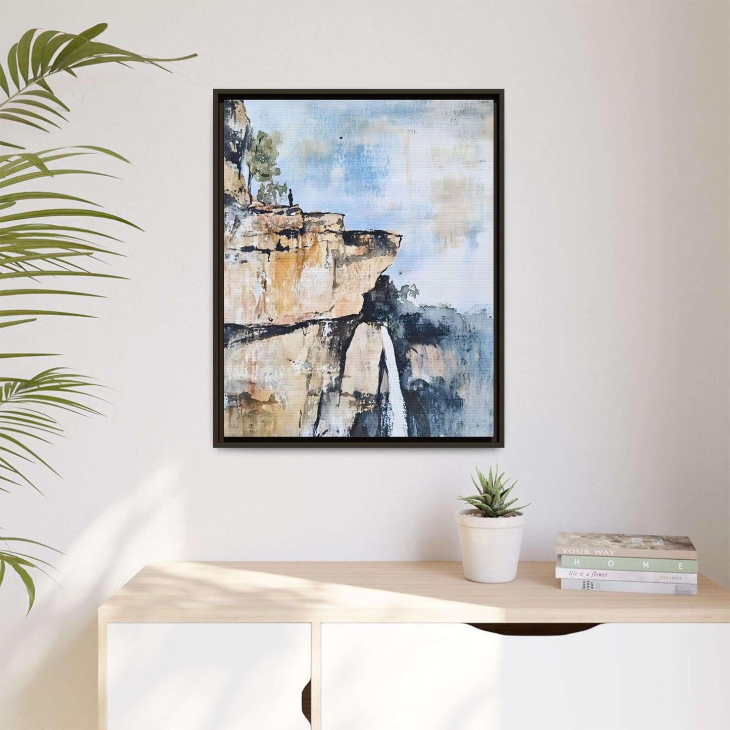 Framed canvas wall art of an impressionistic waterfall landscape in a serene room setting.