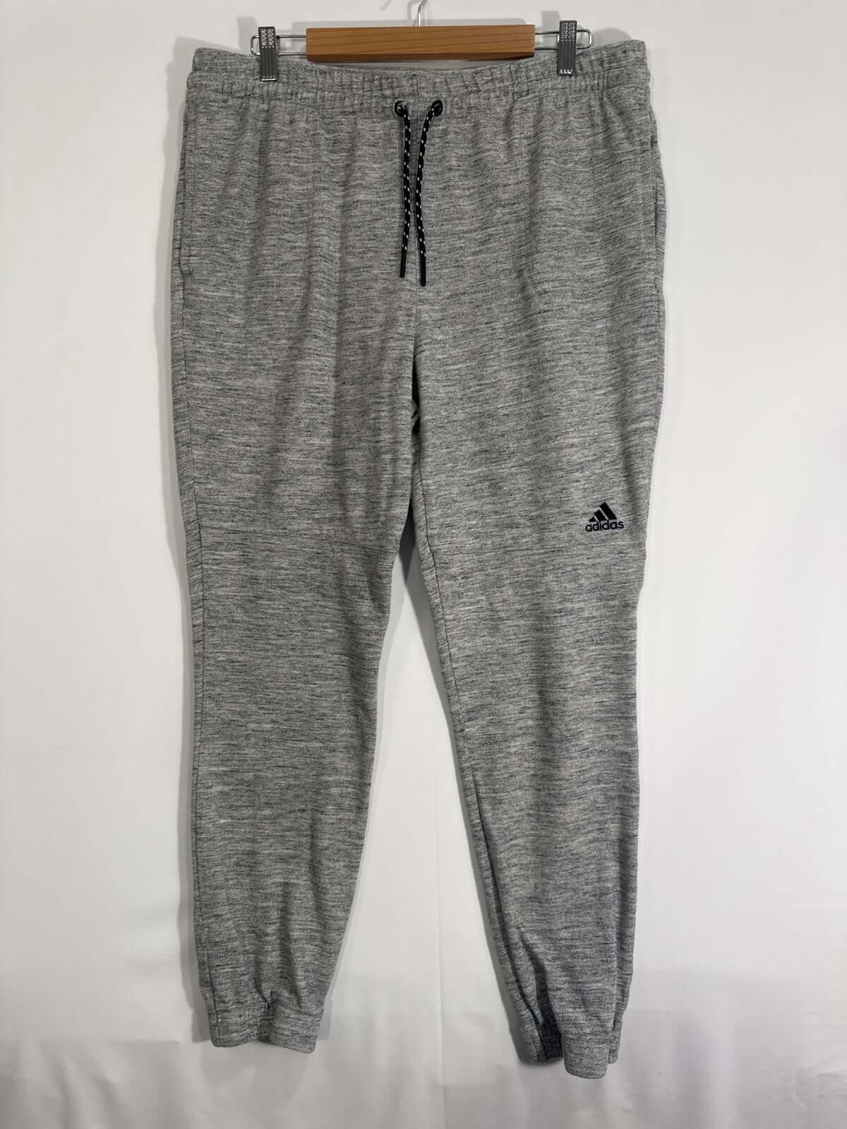 Adidas Jogger Pants in grey, featuring elastic waistband and drawstring, tapered legs, and classic logo, ideal for athletic wear.
